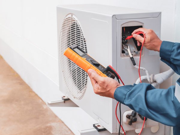 Technician servicing a residential heating system in Corrales